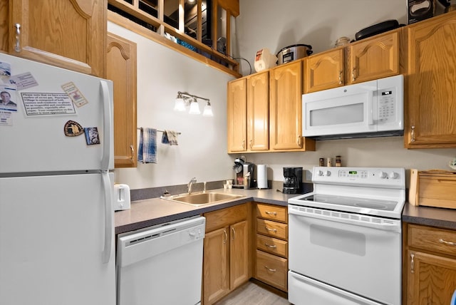 32 Alder Way Unit 4C, Whitefish, MT 59937 - kitchen featuring white appliances, dark countertops, and light wood-type flooring