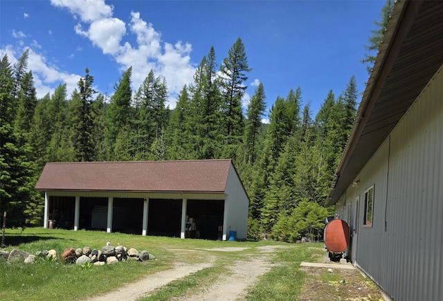 401 Western Larch Ln, Yaak, MT 59935 - view of front of home featuring a wooded view and an outbuilding