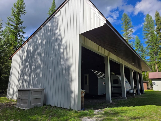 401 Western Larch Ln, Yaak, MT 59935 - view of side of property featuring a pole building, a lawn, and an outdoor structure