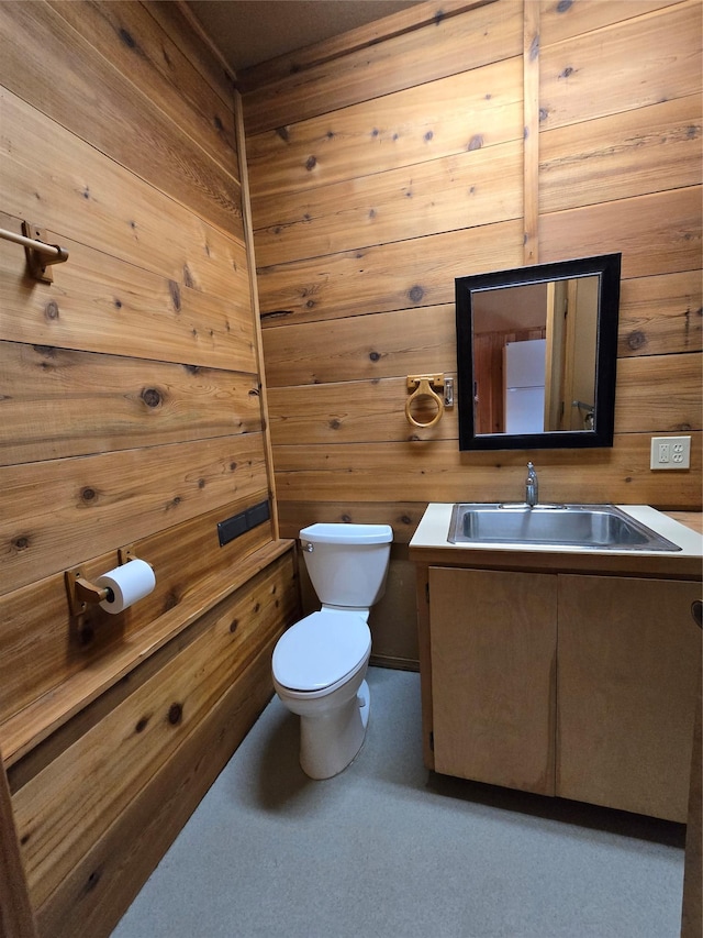 401 Western Larch Ln, Yaak, MT 59935 - half bath featuring toilet, vanity, and wooden walls