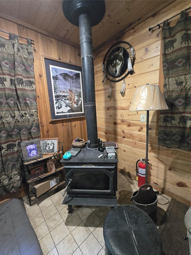 401 Western Larch Ln, Yaak, MT 59935 - living area with a wood stove, wooden walls, tile patterned flooring, and wood ceiling