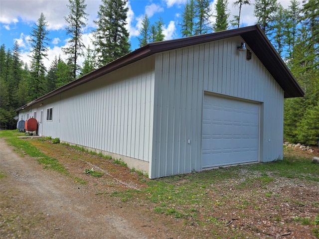401 Western Larch Ln, Yaak, MT 59935 - view of home's exterior with a garage, an outbuilding, and dirt driveway