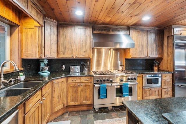 655 Leksand Trl, Whitefish, MT 59937 - kitchen with range hood, high end appliances, recessed lighting, stone tile flooring, and decorative backsplash