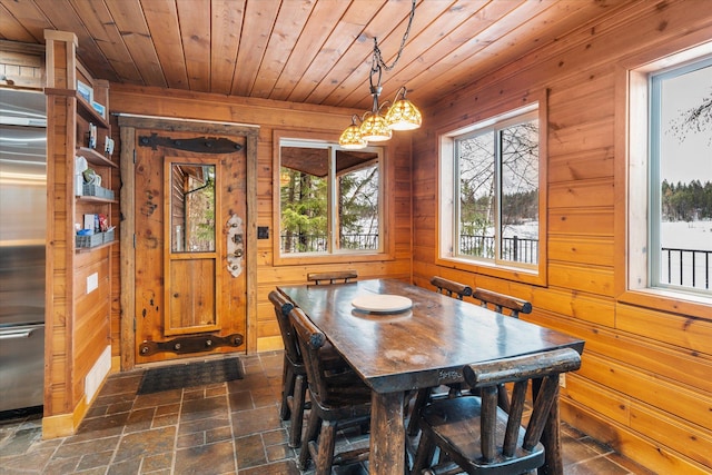 655 Leksand Trl, Whitefish, MT 59937 - dining area with wooden ceiling, wooden walls, a chandelier, and dark stone finish floors