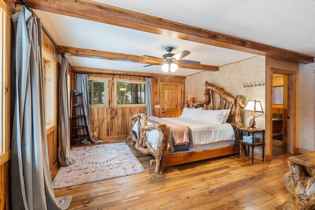 655 Leksand Trl, Whitefish, MT 59937 - bedroom with hardwood / wood-style floors, beam ceiling, and a ceiling fan