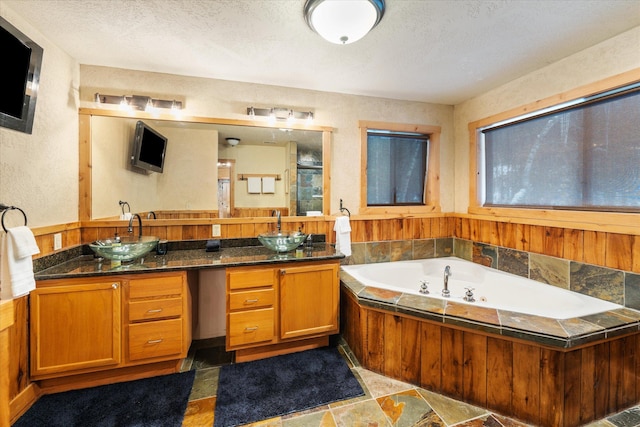 655 Leksand Trl, Whitefish, MT 59937 - bathroom featuring double vanity, a whirlpool tub, an enclosed shower, and a textured ceiling