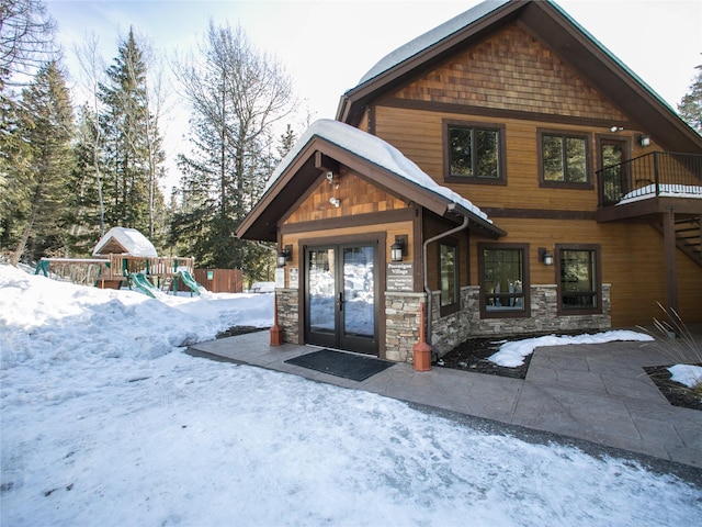 97 Cedar Way Unit 97, Whitefish, MT 59937 - rustic home featuring a playground, french doors, stone siding, and fence