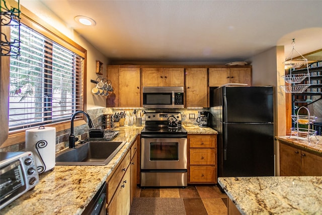 97 Cedar Way Unit 97, Whitefish, MT 59937 - kitchen with appliances with stainless steel finishes, a sink, and brown cabinets
