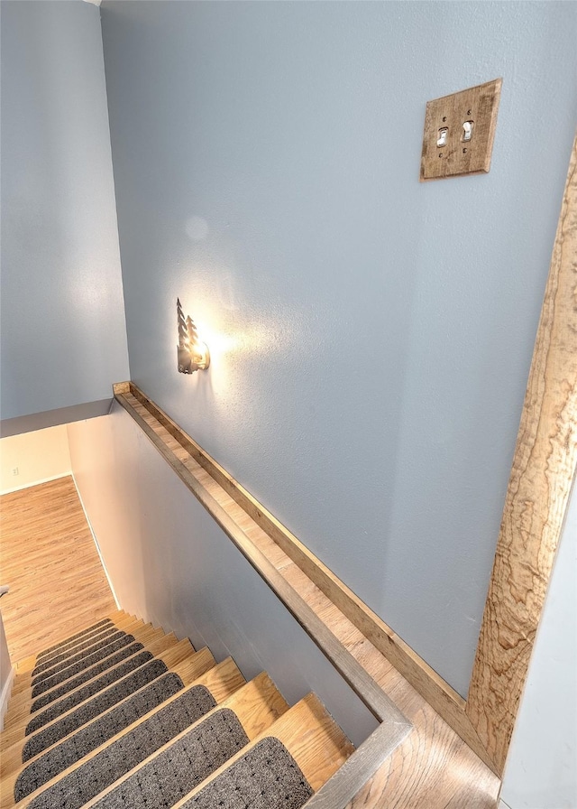 stairway with wood finished floors