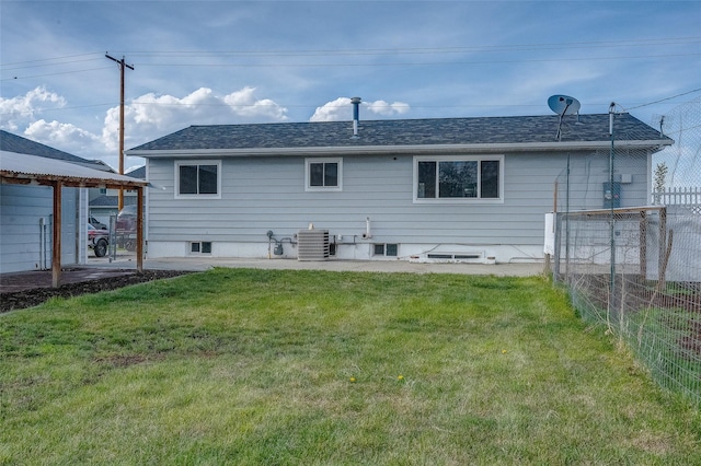 rear view of house with central AC unit and roof with shingles