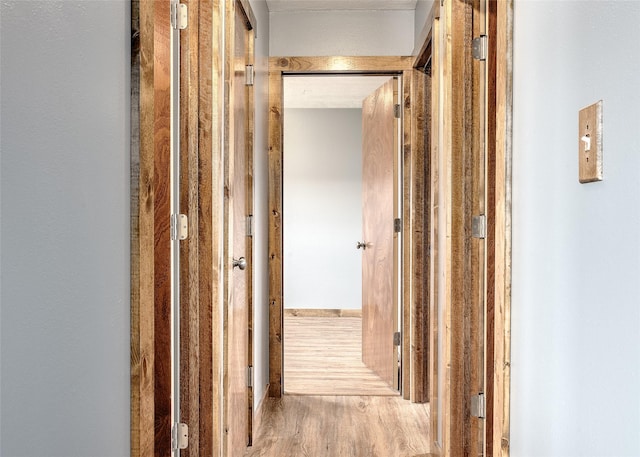 corridor featuring wood finished floors
