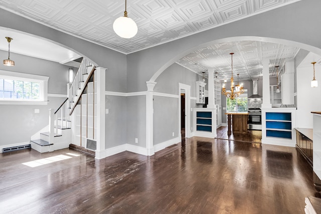 705 N 3rd St W, Missoula, MT 59802 - unfurnished living room with an ornate ceiling, wood finished floors, a chandelier, and baseboards