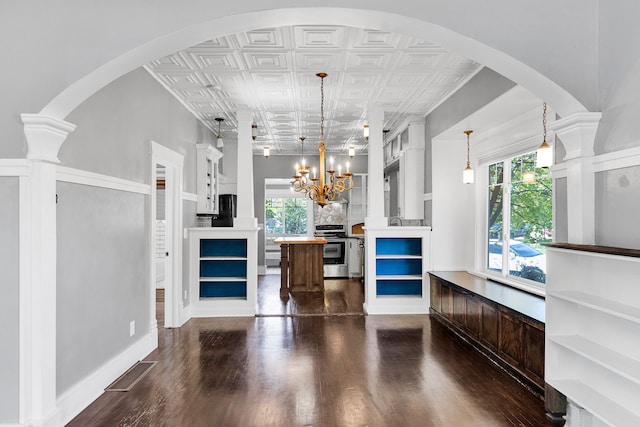 705 N 3rd St W, Missoula, MT 59802 - living room with an ornate ceiling, a chandelier, dark wood finished floors, and arched walkways