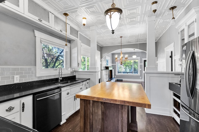 705 N 3rd St W, Missoula, MT 59802 - kitchen with dishwashing machine, a sink, freestanding refrigerator, a chandelier, and white cabinets