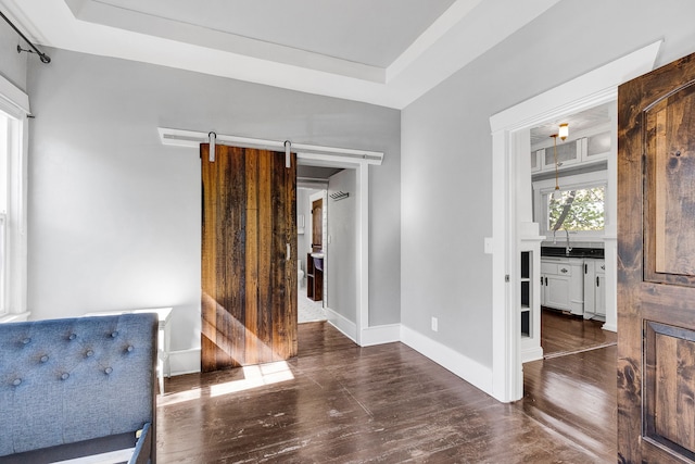 705 N 3rd St W, Missoula, MT 59802 - unfurnished room featuring wood finished floors, baseboards, and a barn door