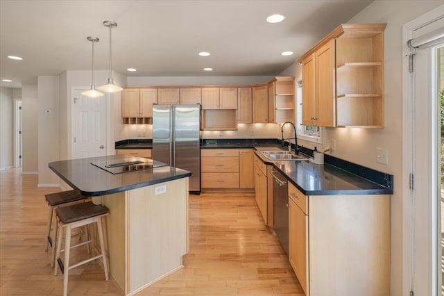 kitchen with stainless steel appliances, open shelves, light brown cabinets, a sink, and light wood finished floors