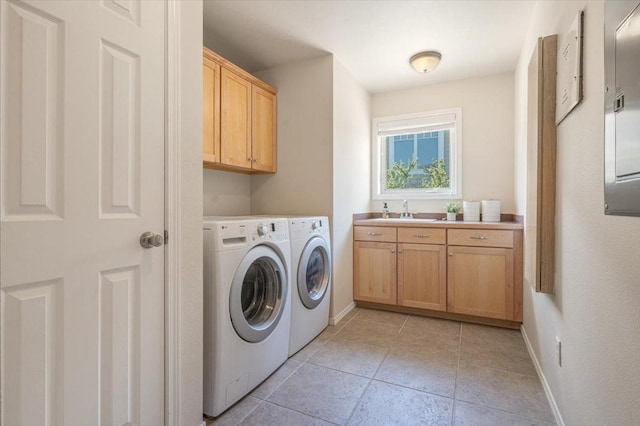laundry room featuring cabinet space, separate washer and dryer, baseboards, and light tile patterned flooring