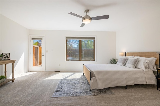 carpeted bedroom with access to exterior, ceiling fan, and baseboards