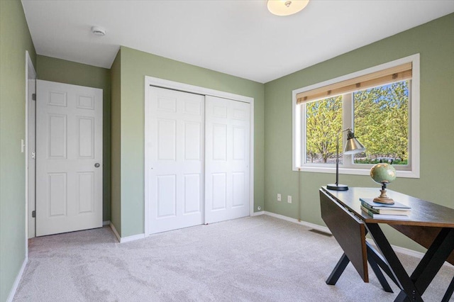 home office featuring light colored carpet and baseboards