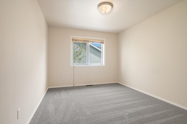 unfurnished room featuring carpet flooring and baseboards