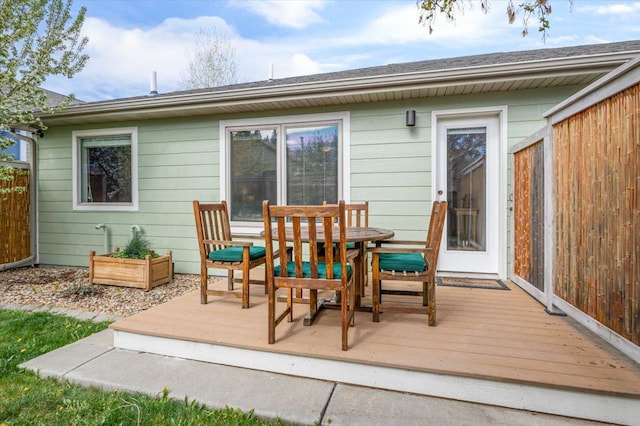 wooden terrace with outdoor dining area