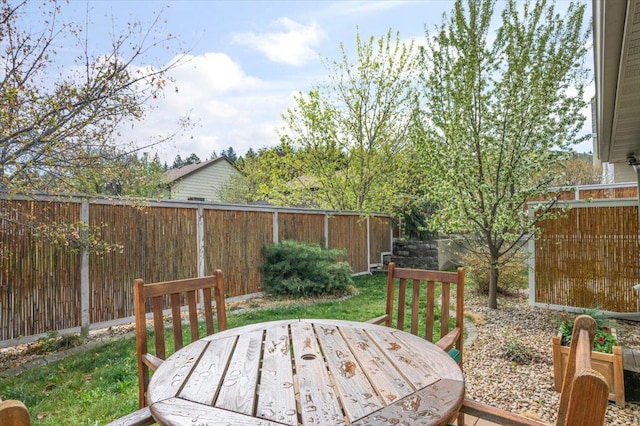 deck with a fenced backyard and outdoor dining space