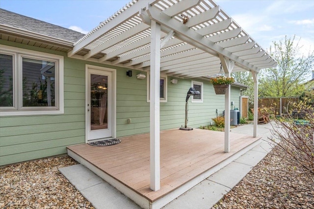 wooden terrace featuring a pergola, fence, and cooling unit
