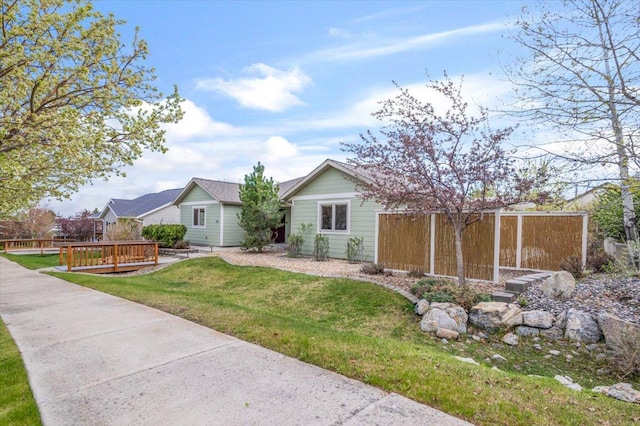 single story home featuring a wooden deck