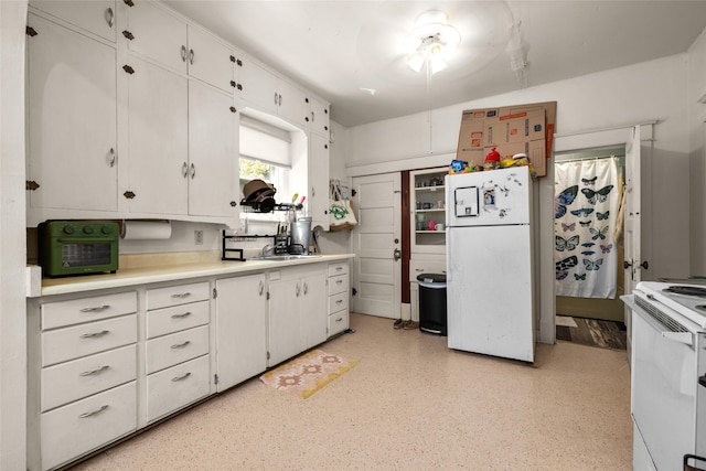 528 3rd Ave E, Kalispell, MT 59901 - kitchen featuring white appliances, light countertops, white cabinetry, and a sink