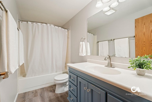 full bathroom featuring wood finished floors, vanity, toilet, and shower / tub combo with curtain