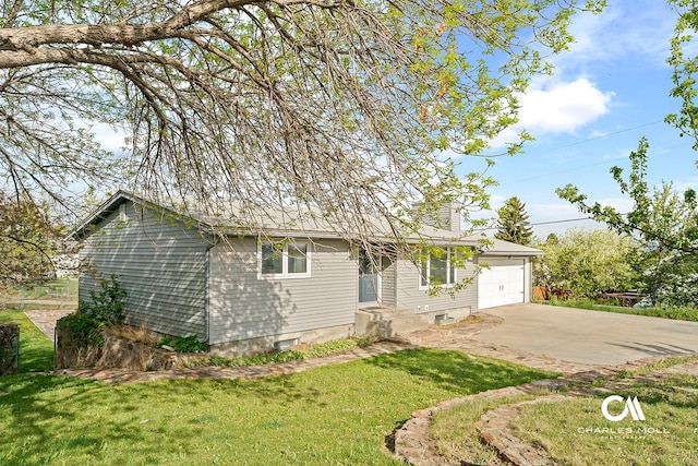 ranch-style home with a front yard, an attached garage, and concrete driveway