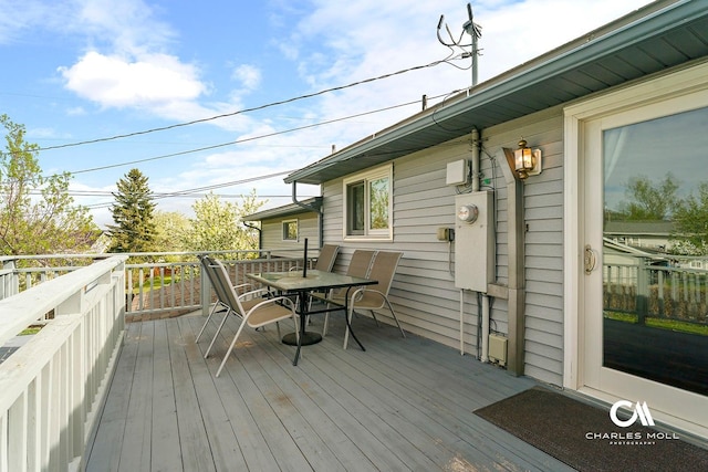 wooden terrace featuring outdoor dining area