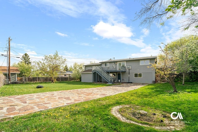 rear view of house with stairs, a wooden deck, and a patio area