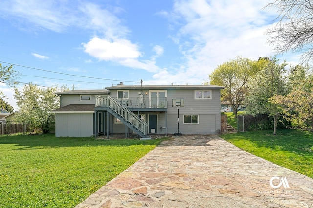 rear view of property featuring stairway and a wooden deck