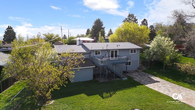 back of property with a deck, stairs, and concrete driveway