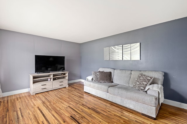 living room featuring wood finished floors and baseboards