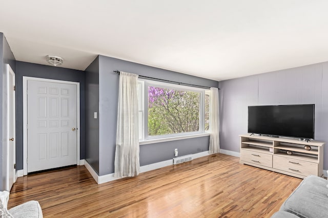 living room featuring wood finished floors and baseboards