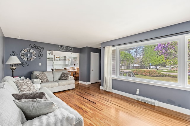 living room featuring baseboards and wood finished floors