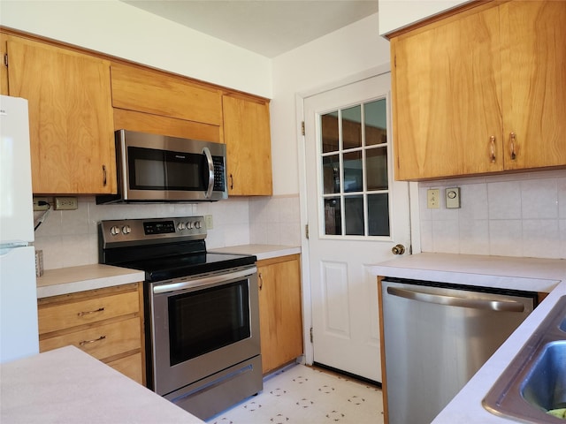 172 Scenery Rd, Libby, MT 59923 - kitchen with stainless steel appliances, light countertops, and decorative backsplash