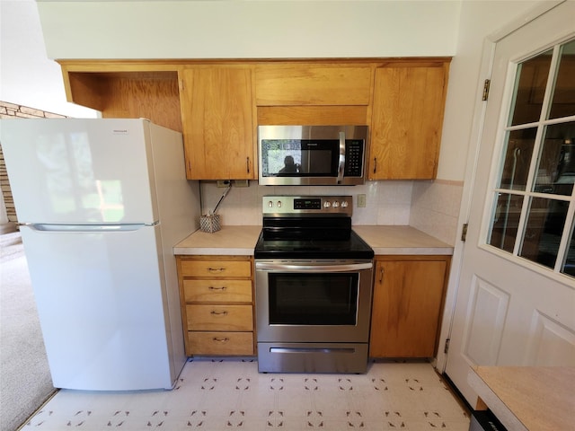 172 Scenery Rd, Libby, MT 59923 - kitchen featuring appliances with stainless steel finishes, light countertops, light floors, and brown cabinets