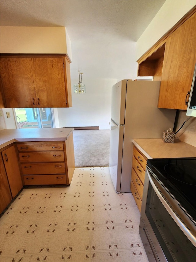 172 Scenery Rd, Libby, MT 59923 - kitchen with stainless steel electric stove, light countertops, light floors, brown cabinetry, and light colored carpet