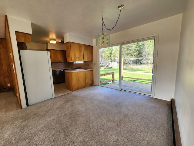 172 Scenery Rd, Libby, MT 59923 - kitchen with freestanding refrigerator, dishwasher, light colored carpet, brown cabinetry, and baseboard heating