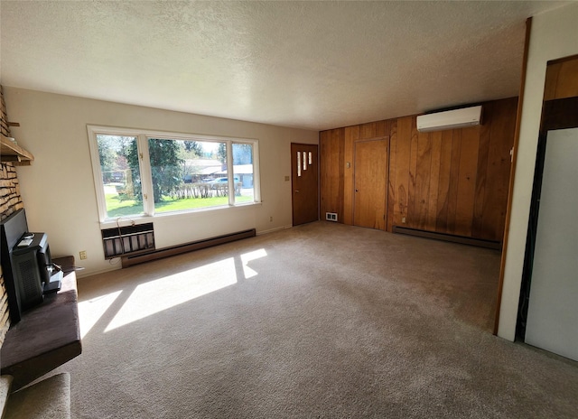 172 Scenery Rd, Libby, MT 59923 - unfurnished living room with a baseboard radiator, a wall unit AC, carpet flooring, a textured ceiling, and wooden walls