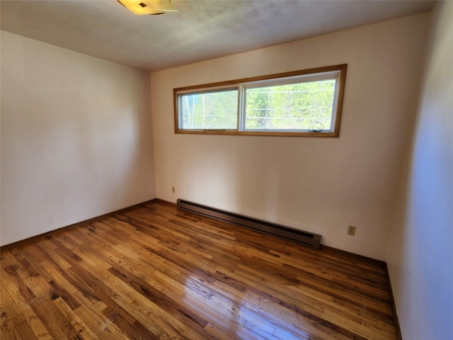 172 Scenery Rd, Libby, MT 59923 - spare room with a baseboard heating unit and wood-type flooring