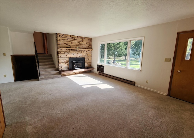 172 Scenery Rd, Libby, MT 59923 - unfurnished living room featuring a baseboard radiator, carpet flooring, stairs, and baseboards