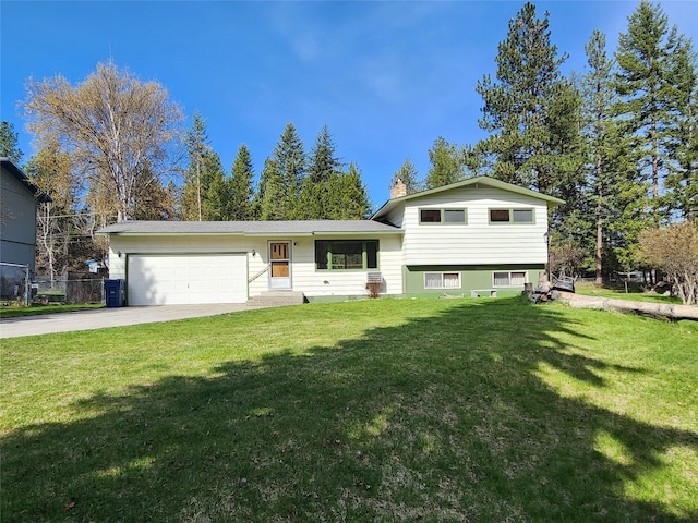 172 Scenery Rd, Libby, MT 59923 - split level home featuring an attached garage, driveway, a front yard, and a chimney