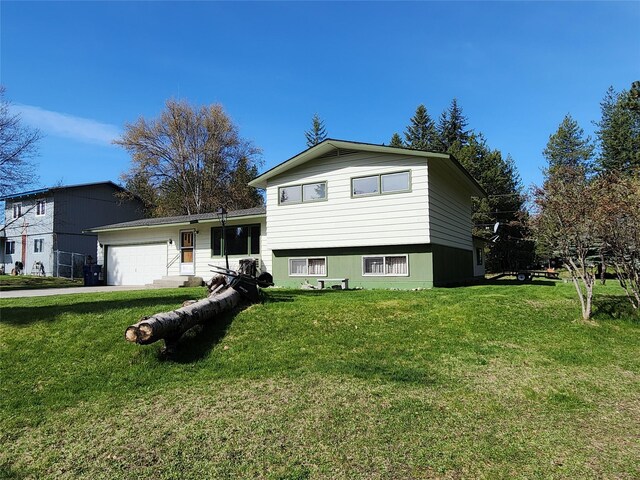 172 Scenery Rd, Libby, MT 59923 - tri-level home featuring a garage and a front lawn