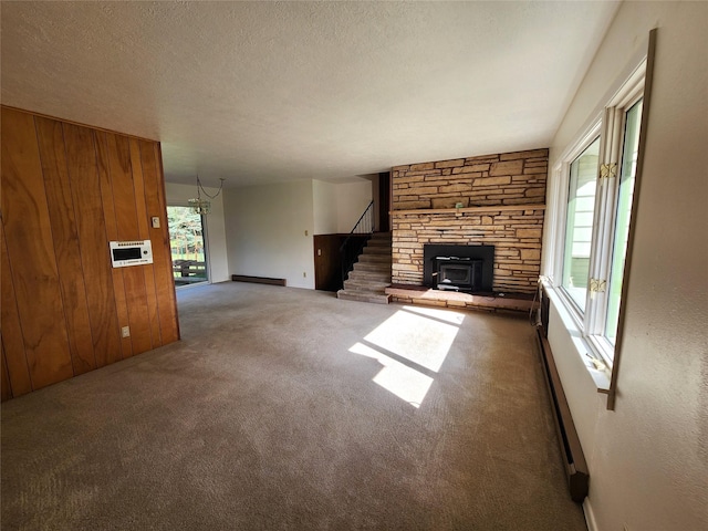 172 Scenery Rd, Libby, MT 59923 - unfurnished living room with carpet flooring, a chandelier, stairway, a textured ceiling, and wooden walls