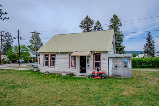 1005 Idaho Ave, Libby, MT 59923 - view of front of property featuring a front lawn and metal roof