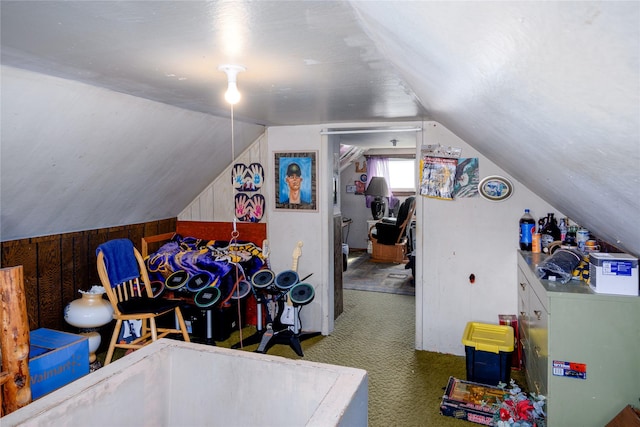 1005 Idaho Ave, Libby, MT 59923 - additional living space featuring carpet flooring, vaulted ceiling, and wooden walls